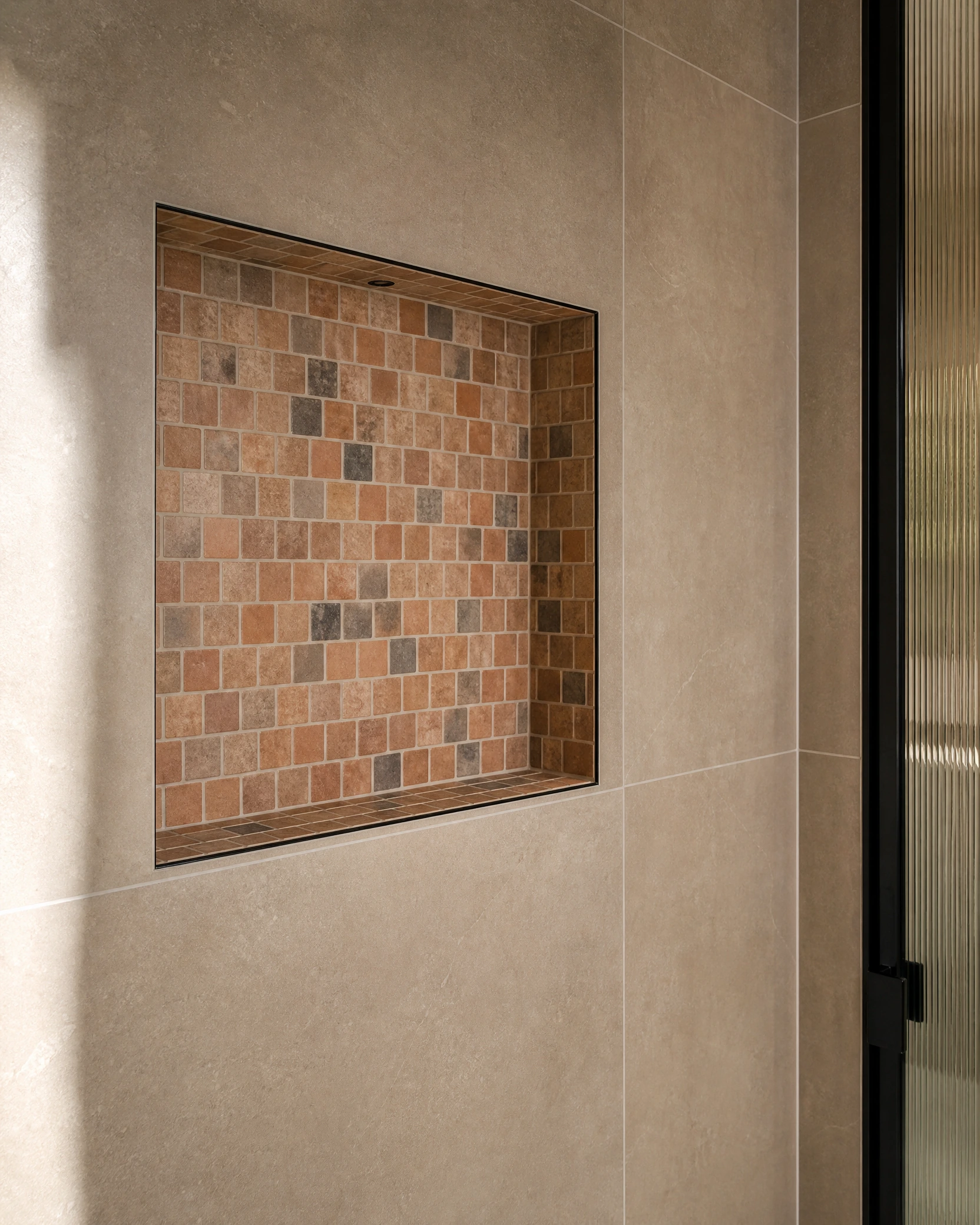 Detailed mosaic shower niche and porcelain wall tile installation